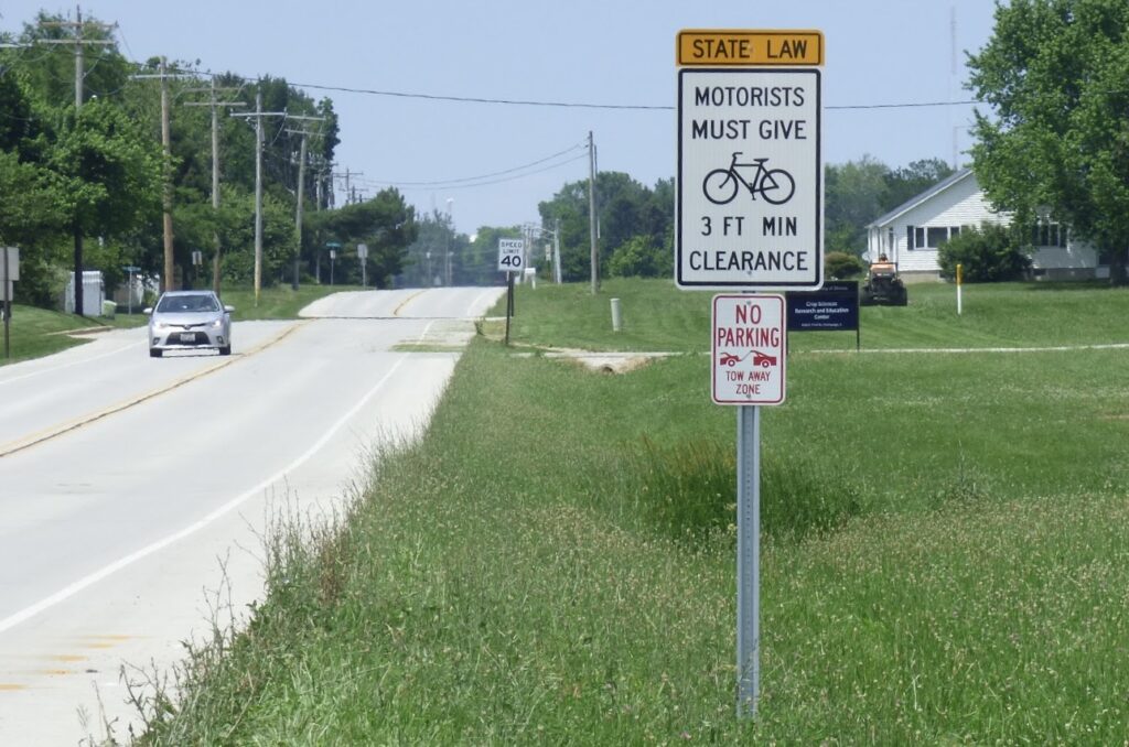 Road sign stating motorists must give bicycles 3 feet of clearance.
